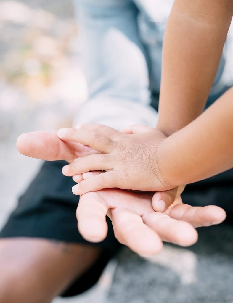 Man holding small child's hand