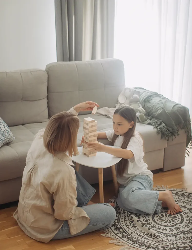 Mother and daughter playing jenga