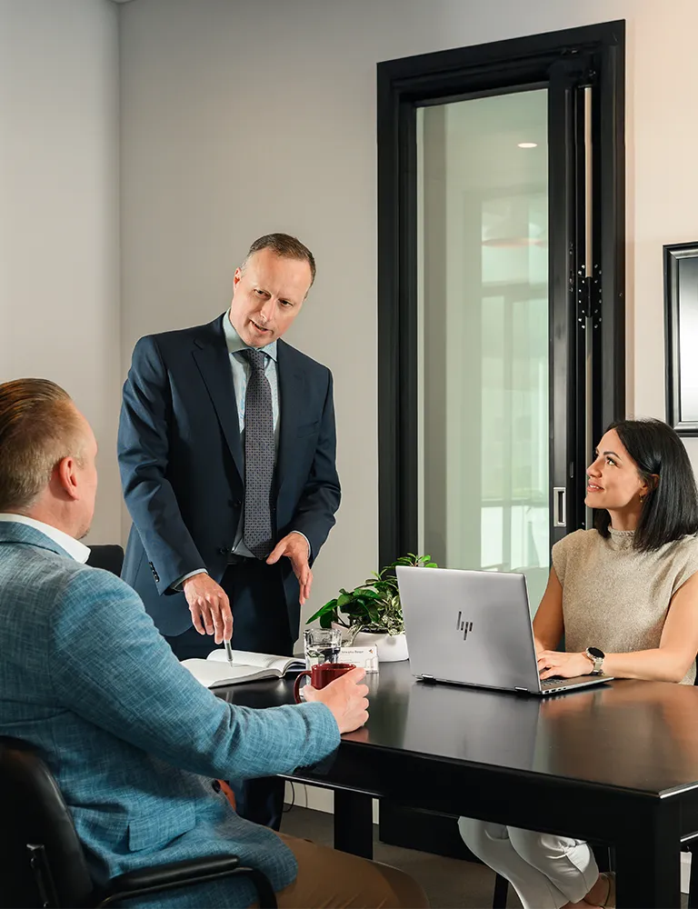 Calgary family lawyer meeting with clients to discuss high-income divorce and property division