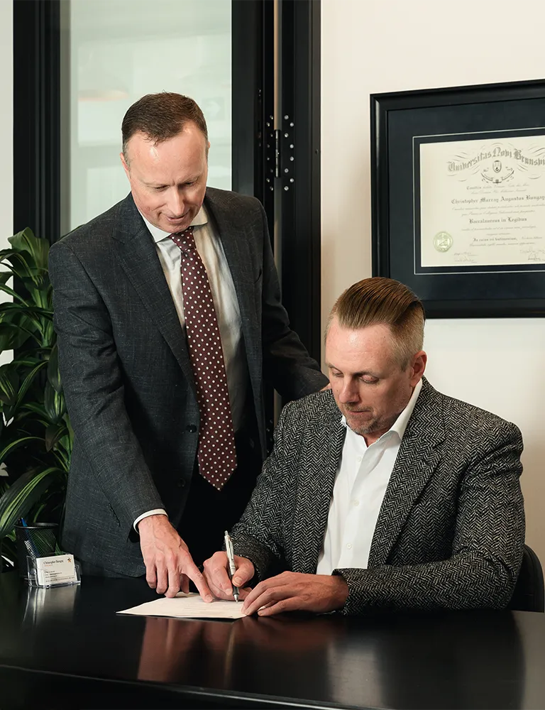 Christopher Bungay reviewing a professional corporation settlement document with a client at Advantage Family Law