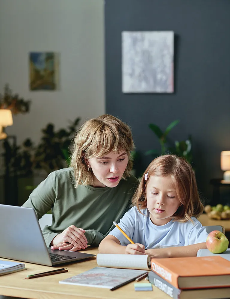 Mother helping daughter with homework