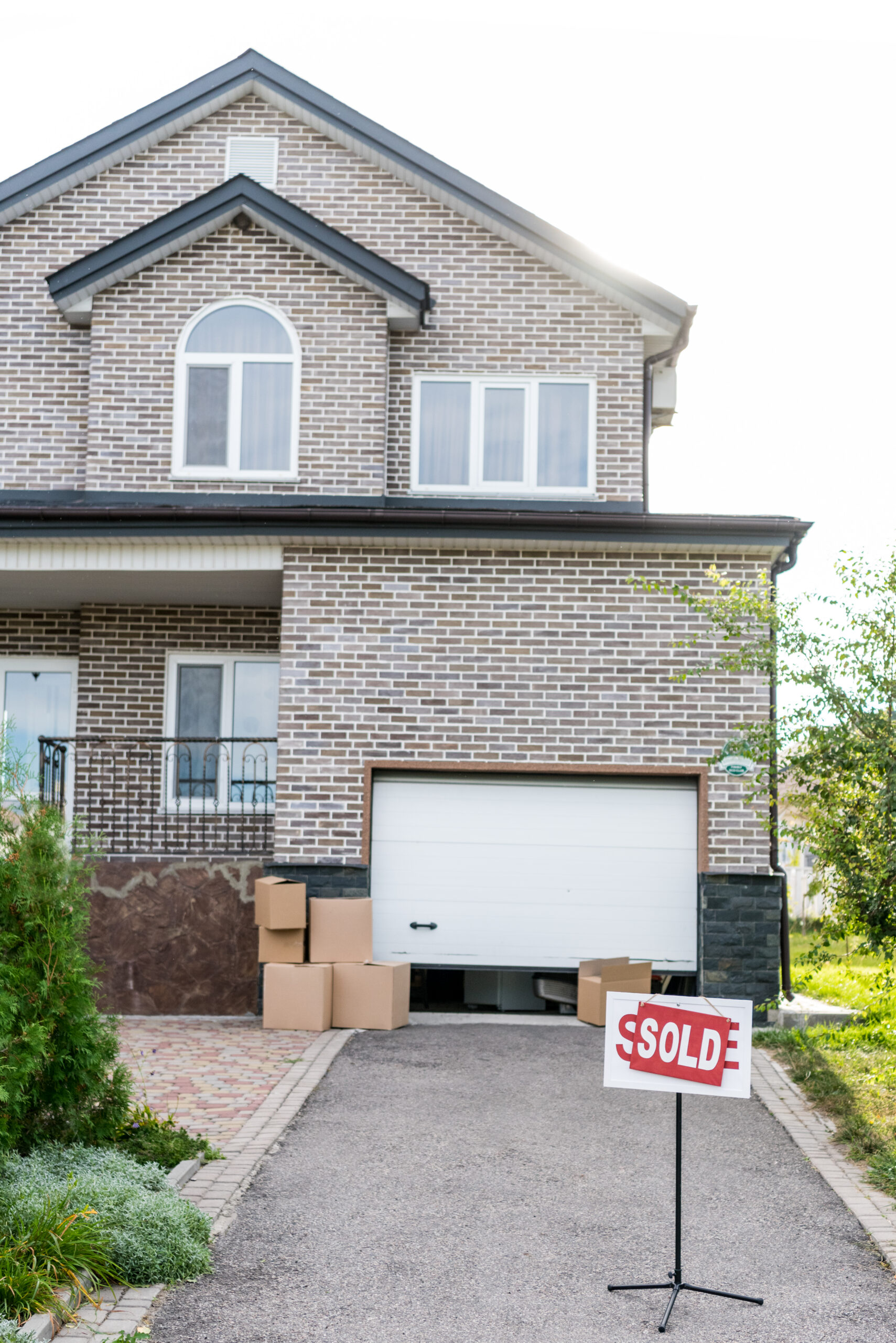 House with "Sold" sign, representing property division in divorce