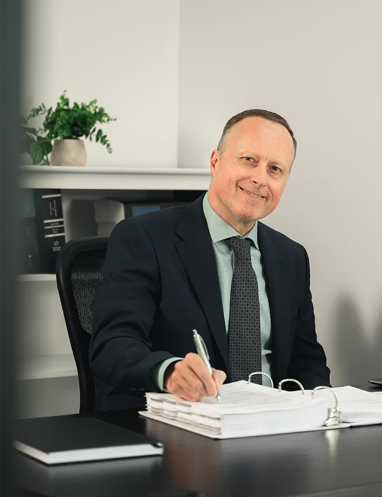 Christopher Bungay, family lawyer at Advantage Family Law, reviewing case documents at his Calgary office desk